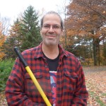 Stanstead Gothic: Hal Newman with rake in hand out on the homestead property.